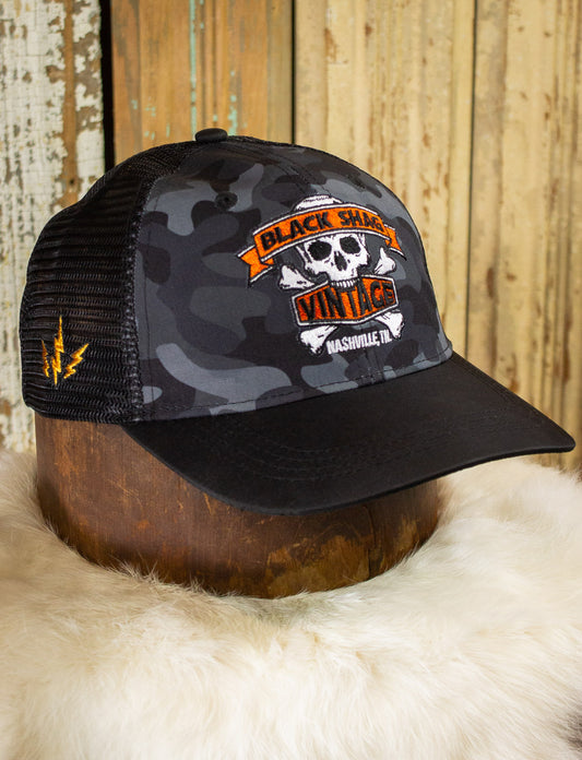 Black Shag Vintage Embroidered Skull + Crossbones Camo Trucker Hat